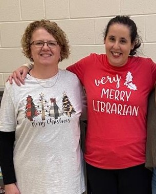 Two female librarians smiling 